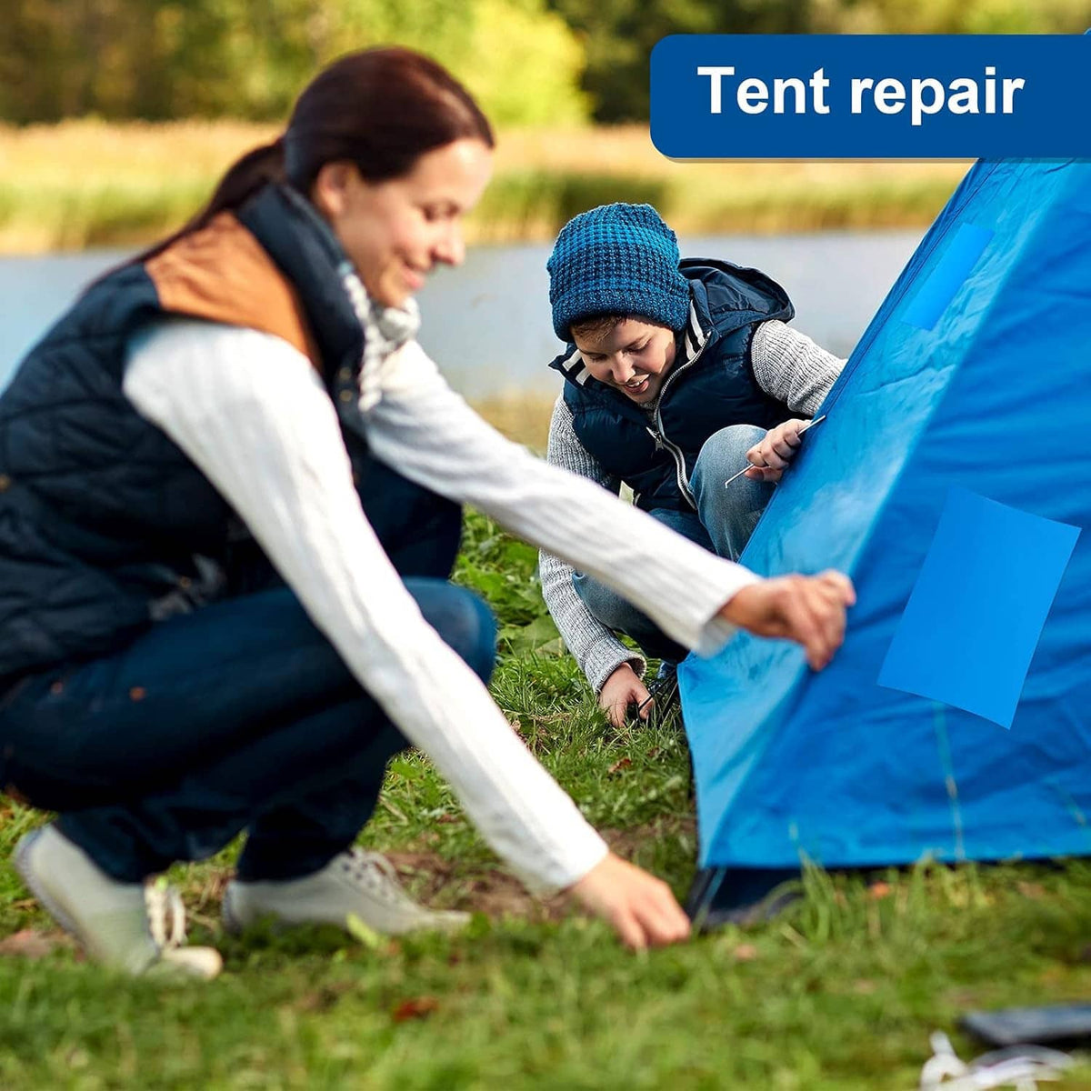 Blue self-adhesive vinyl patch being applied to blue outdoor tent fabric