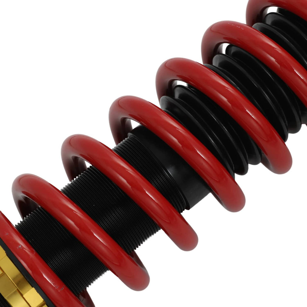 Coilover strut springs with red coils and black upper housing, close-up
