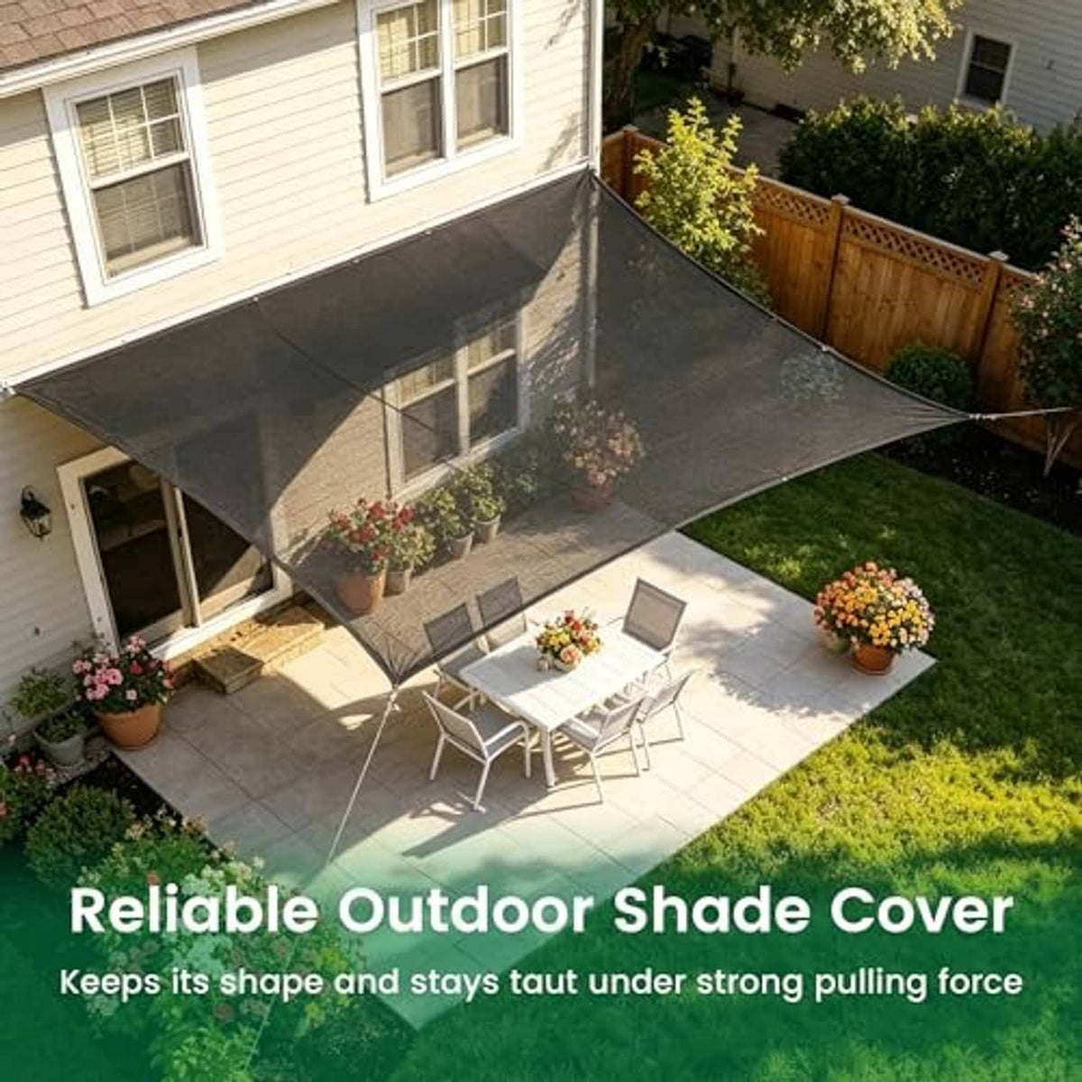 Black 70% outdoor shade cover stretched across backyard corner, with rope ties
