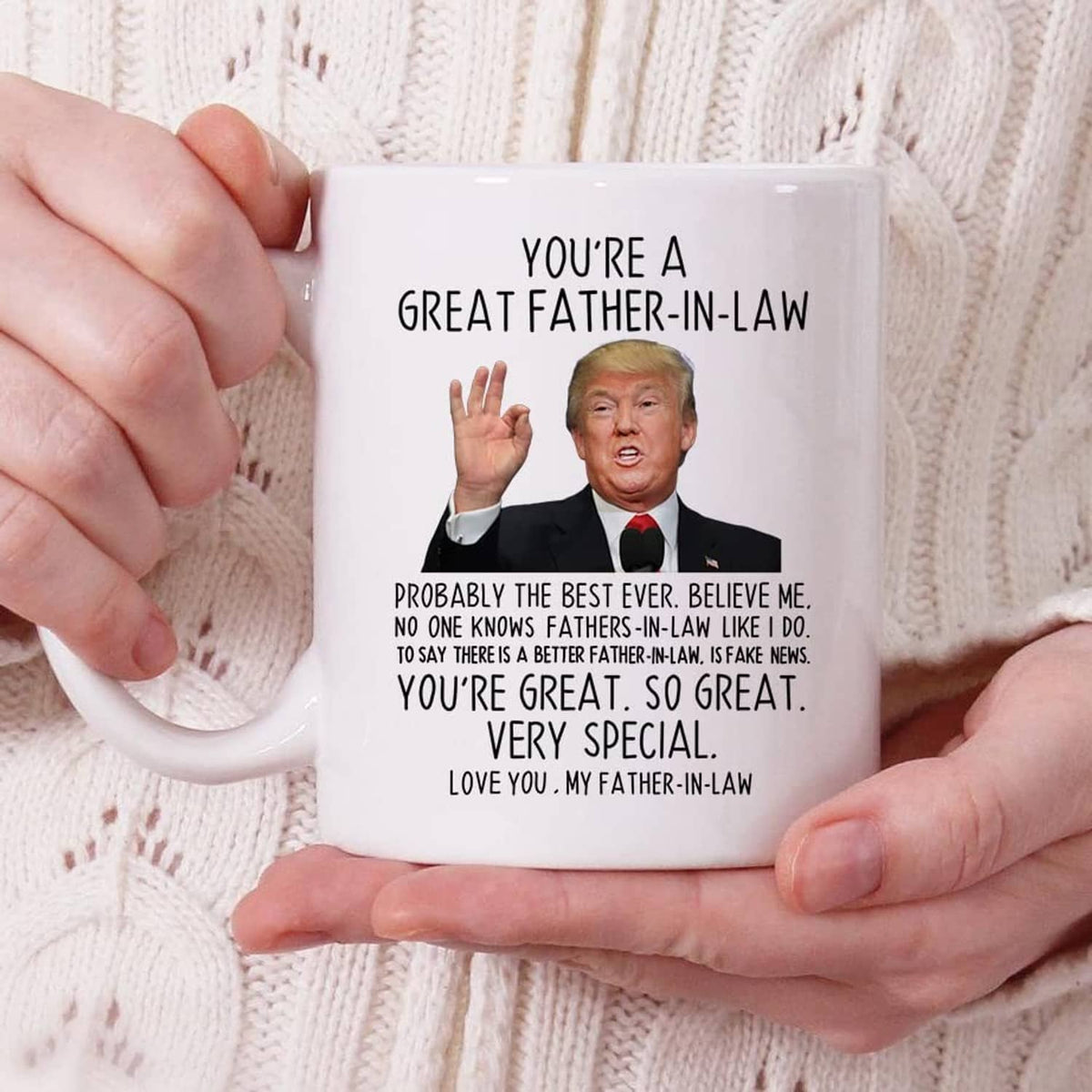 White coffee mug in hands with printed "You're a Great Father-in-Law" message and portrait