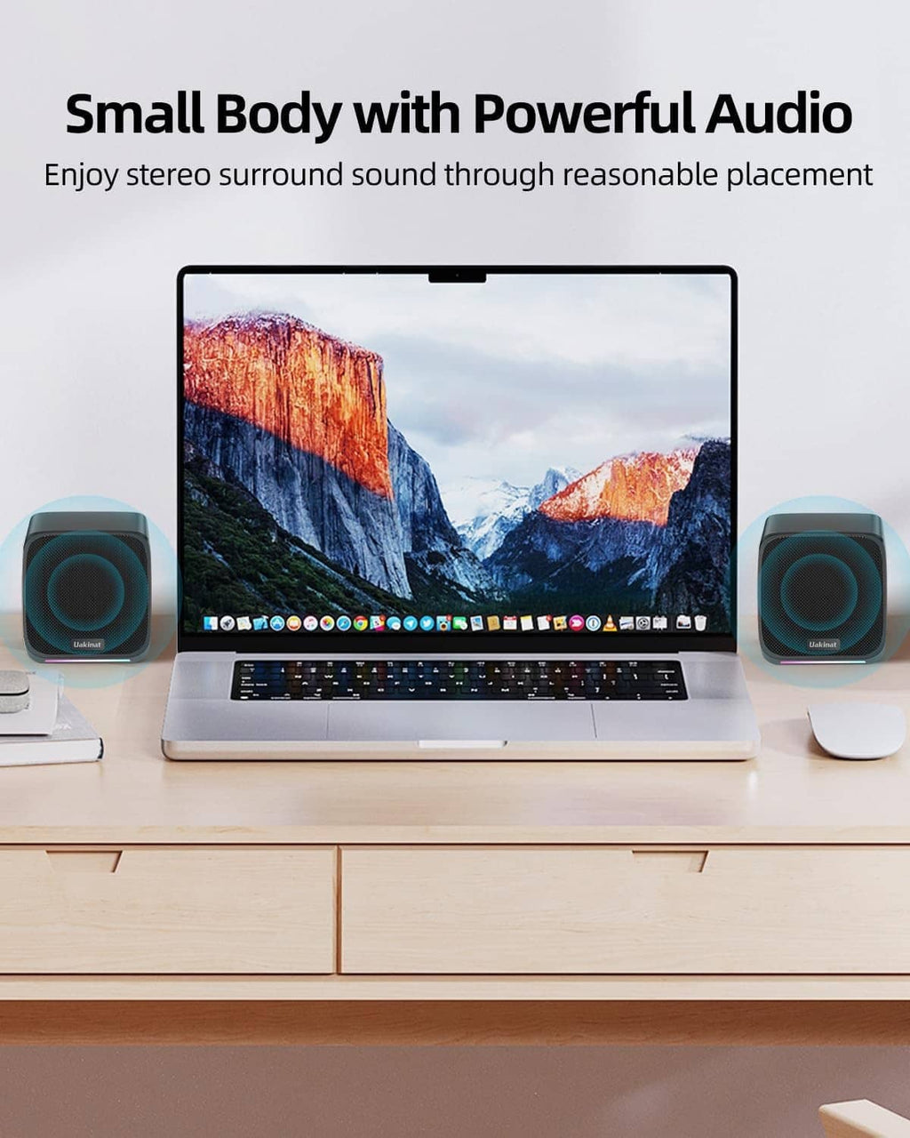 Compact black stereo speakers for desktop PC, two units on a desk setup