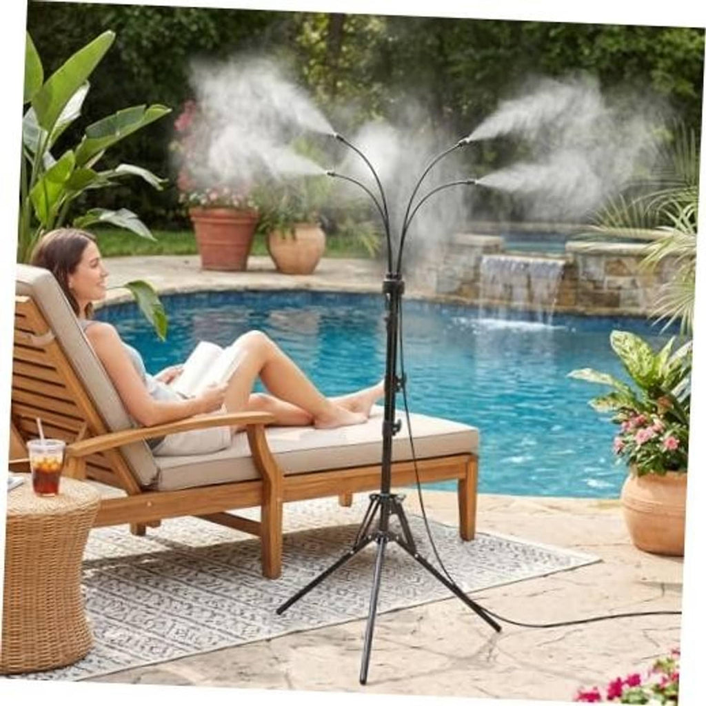 Outdoor misting sprinkler tripod spraying fine mist beside pool patio lounge