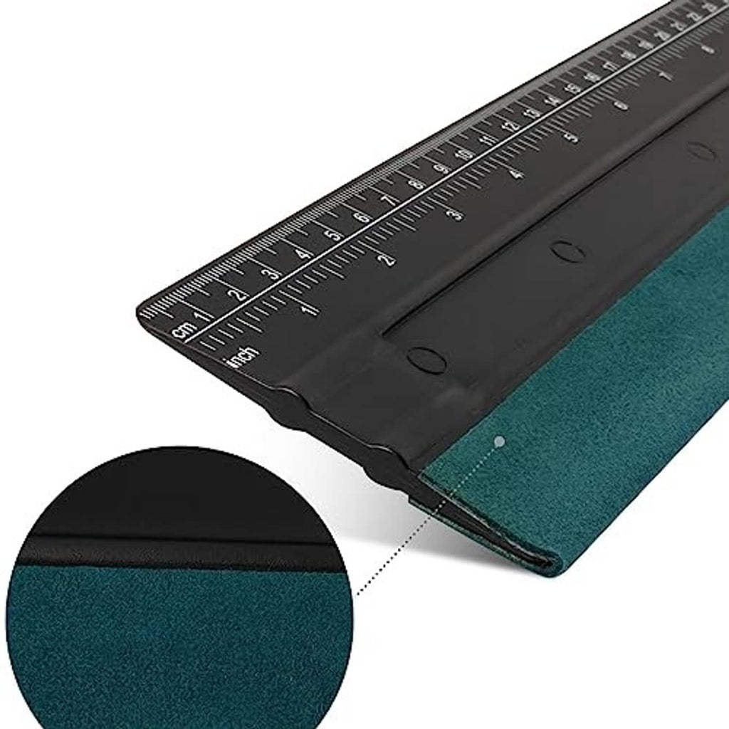 Corner close-up of black squeegee blade with ruler scale and teal felt pad edge.