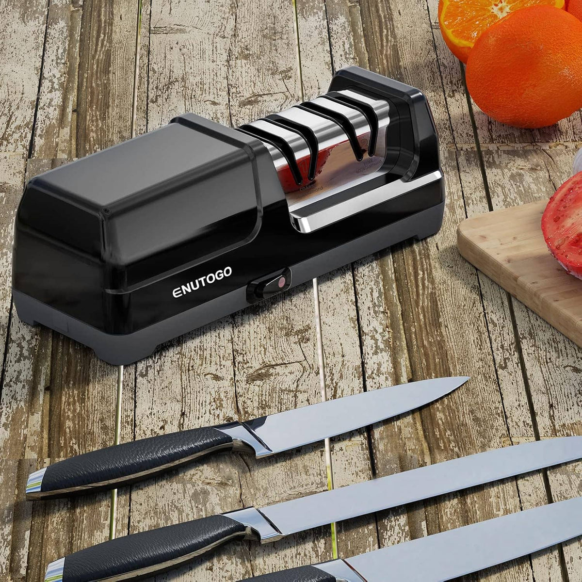 Black ENUTOGO electric knife sharpener on wood surface with a chef’s knife nearby