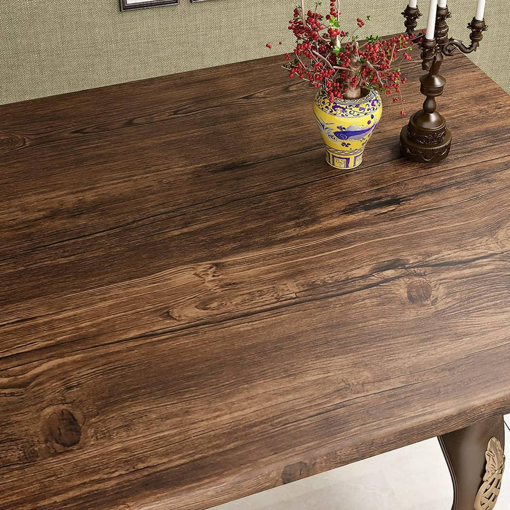 Brown faux wood grain contact paper on countertop corner with streaks and knots