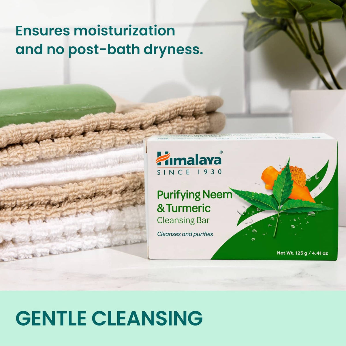Neem & Turmeric cleansing bar box beside green soap bar on towel