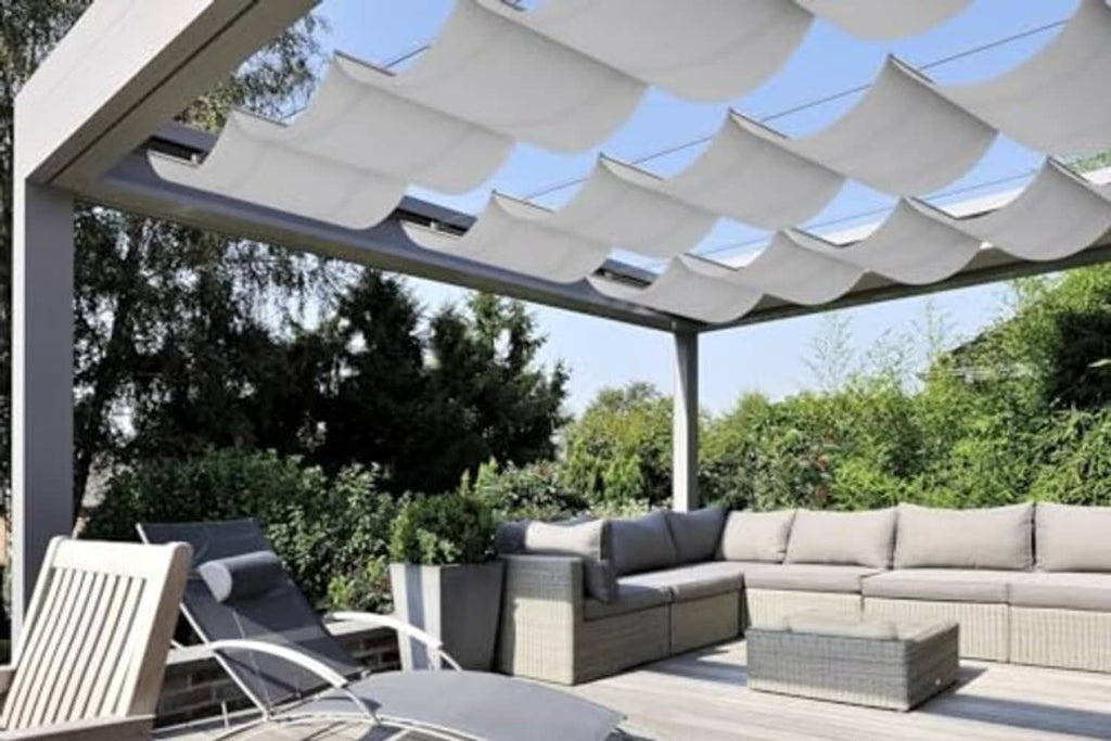 White wave retractable pergola shade canopy stretched over an outdoor seating area