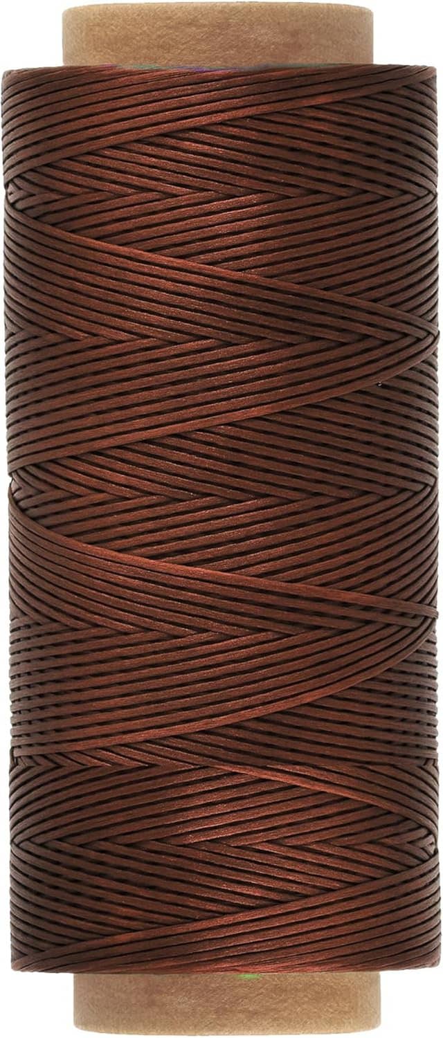 Brown waxed cord spool with neatly wound thread strands on cardboard core