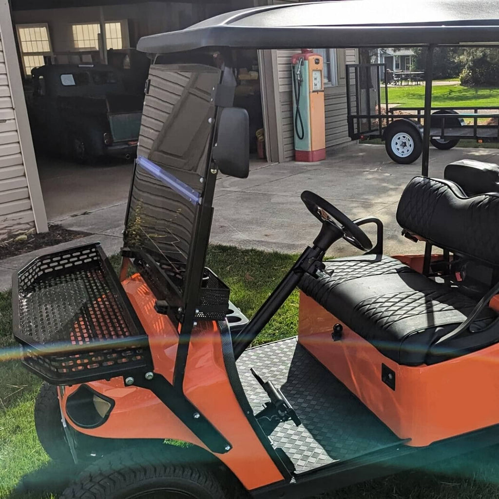 Side view of tinted fold-down windshield on golf cart with black frame and smoky panel.