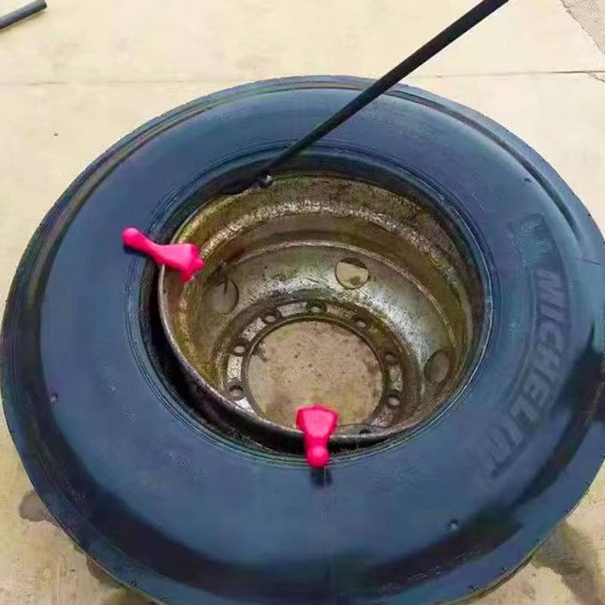 Blue tire rim with two red bead keepers on the inner bead area