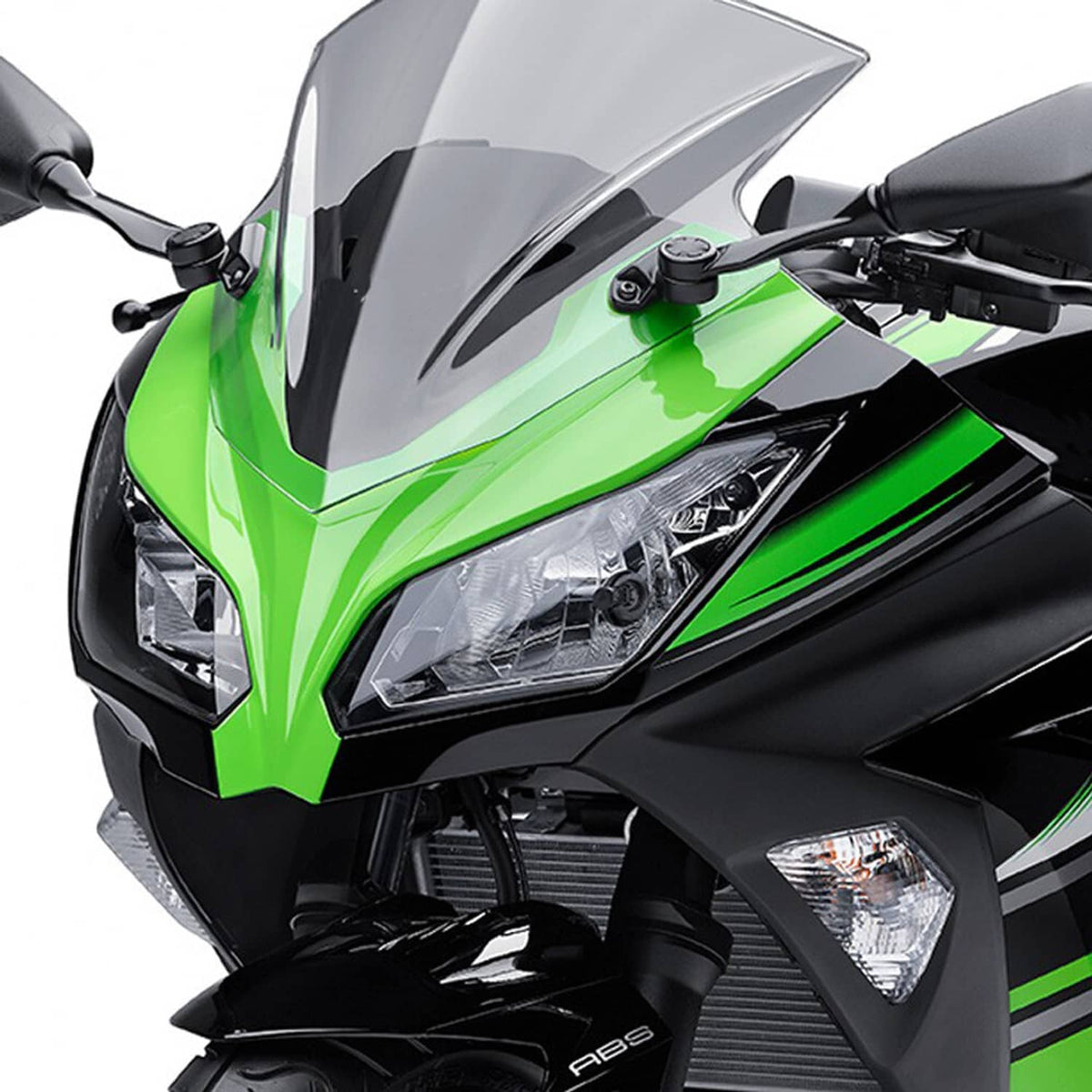 Motorcycle headlight on green sport fairing with clear lens and black trim