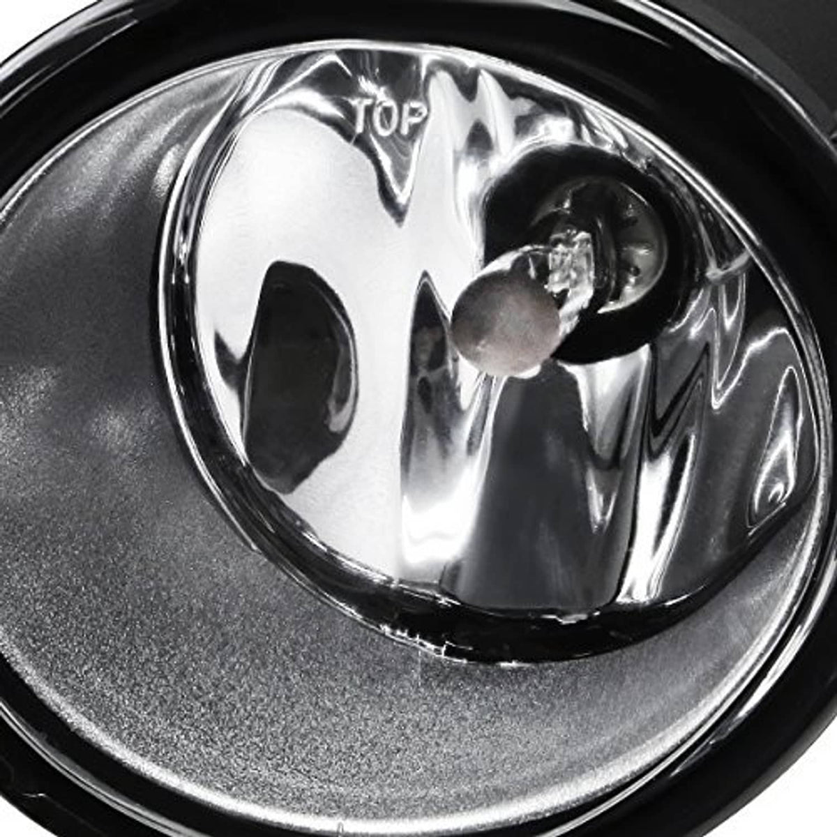 Clear-lens front fog light close-up with chrome reflector and black outer ring