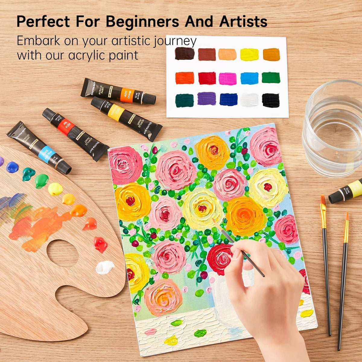 Acrylic paint set tubes with a painted flower canvas and paint palette