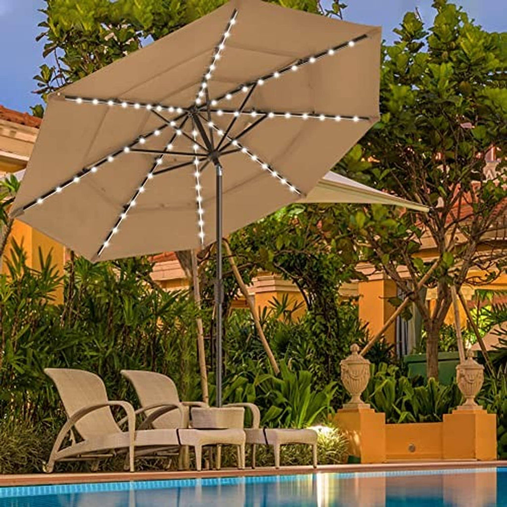 Heather beige patio market umbrella with LED light strings open over outdoor seating.