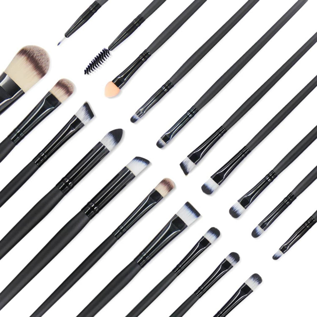 Assorted makeup brushes laid out, black handles with soft beige and white bristles
