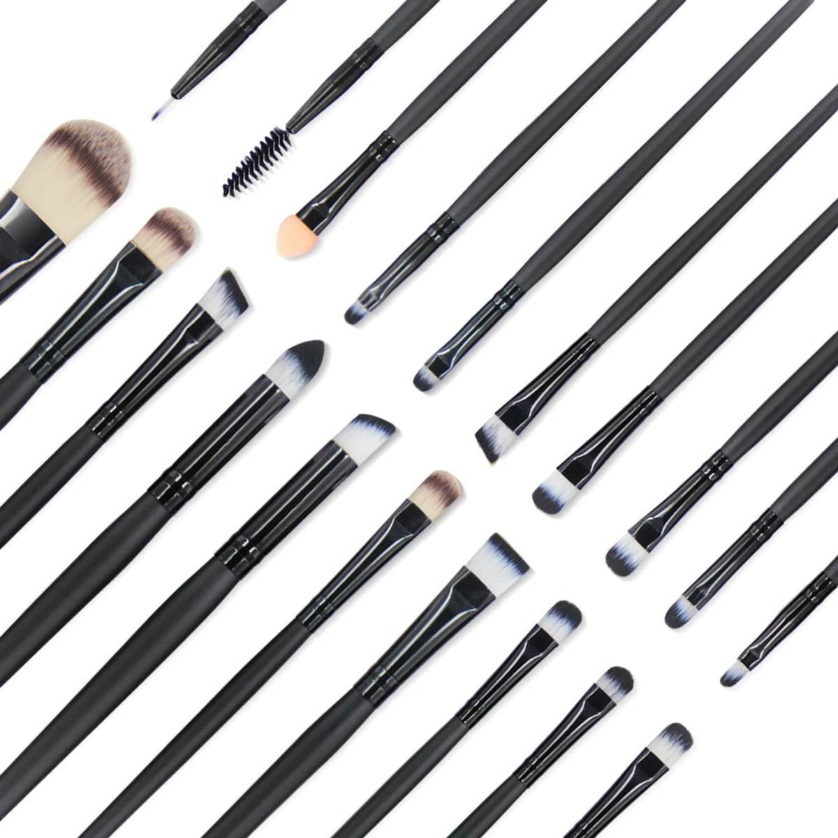 Assorted makeup brushes laid out, black handles with soft beige and white bristles