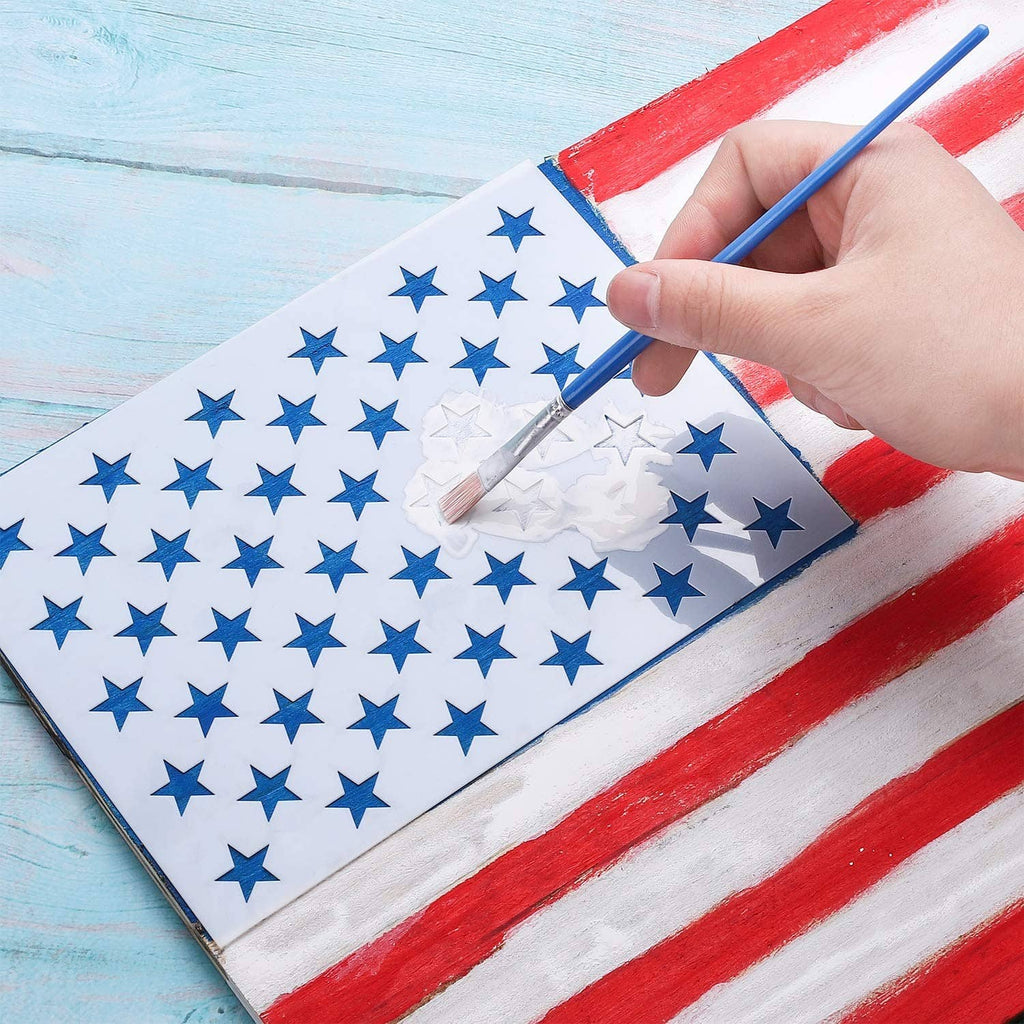 Painting over striped surface with blue star stencil template held in hand