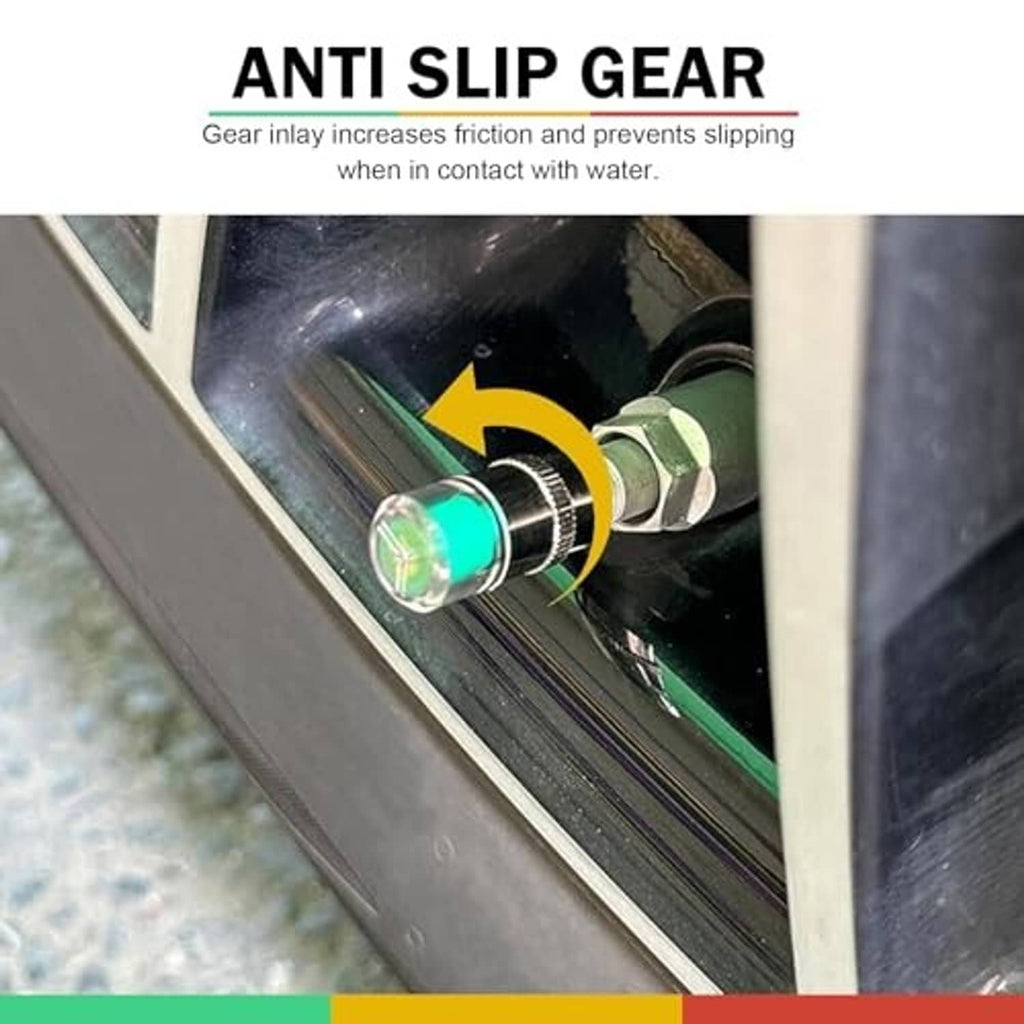 Silver tire valve stem cap installed on wheel valve stem with green indicator light