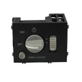 Black dash headlight switch with round knob, dome override, and OFF markings