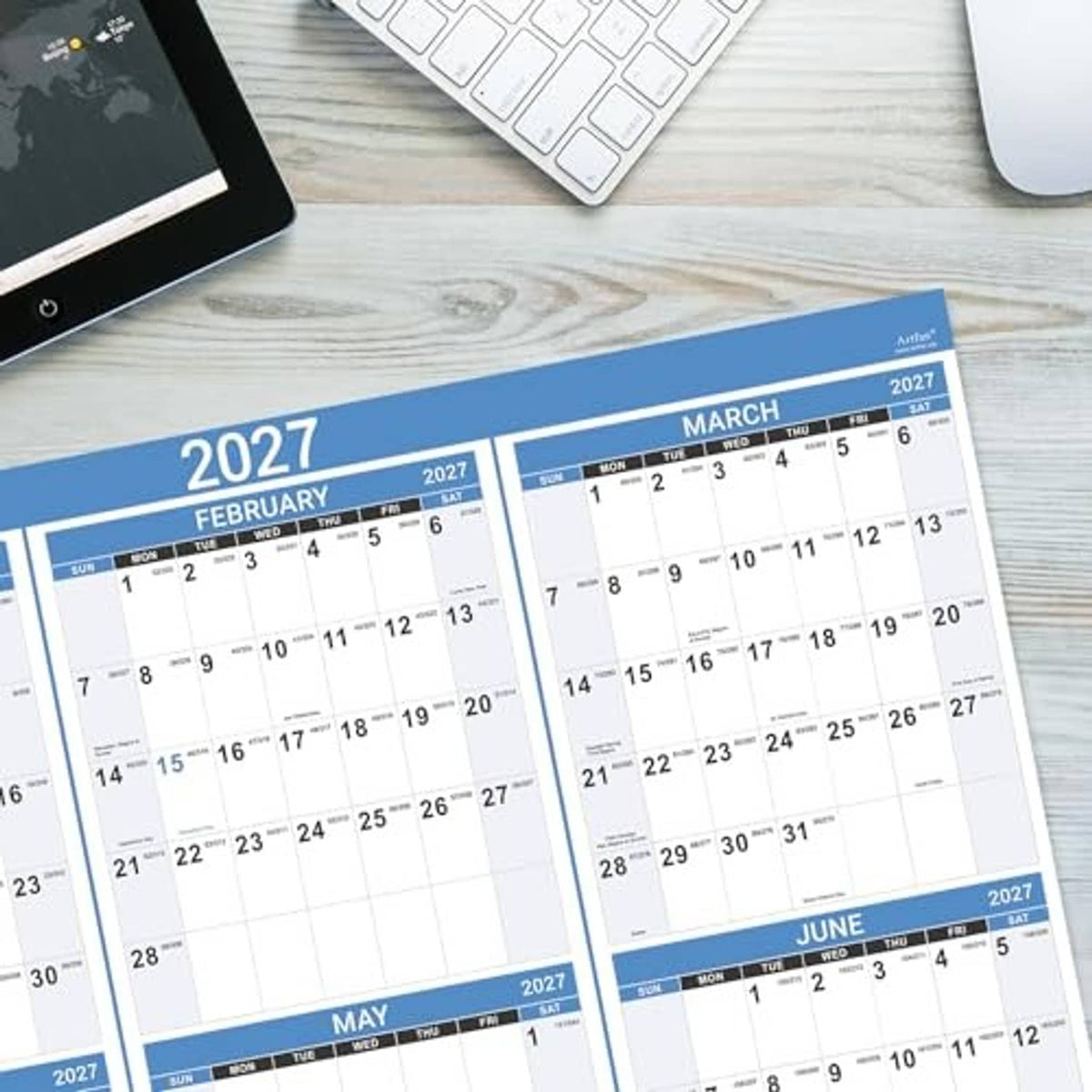 2027 wall calendar pages fanned on a desk, showing February to June month grids.