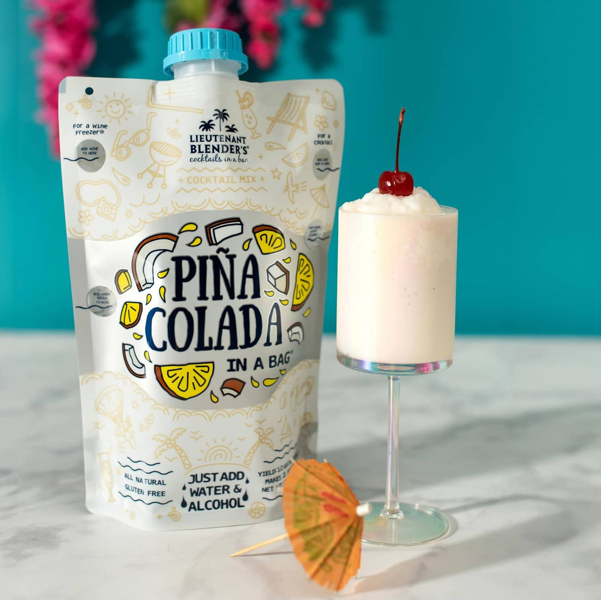 Pina colada cocktail mix pouch with creamy pale-yellow cocktail in a goblet