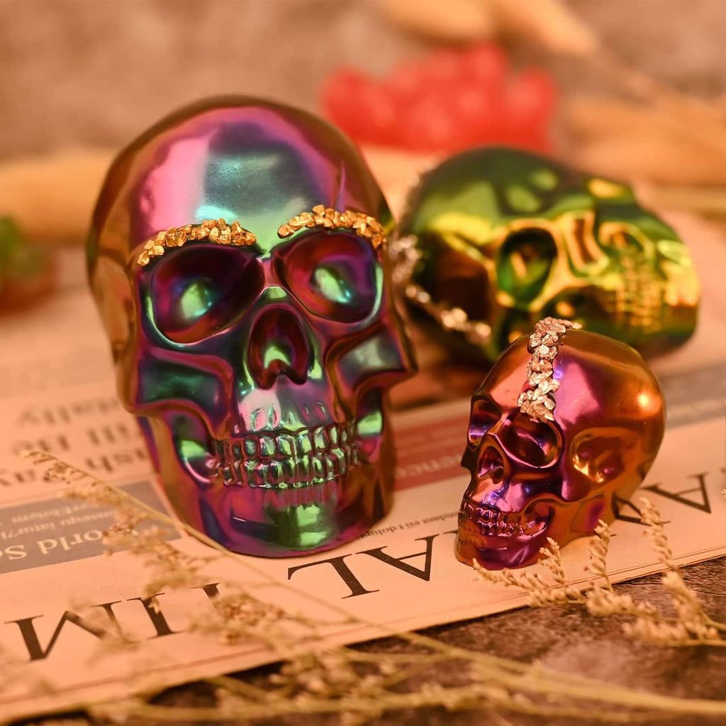 Three skull resin casts with faceted colors from transparent silicone molds