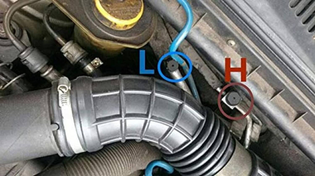 Black AC valve cap on metal service port, ribbed sleeve dust cover