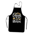 Black kitchen apron with front pocket and gold "Queen of the Kitchen" graphic text