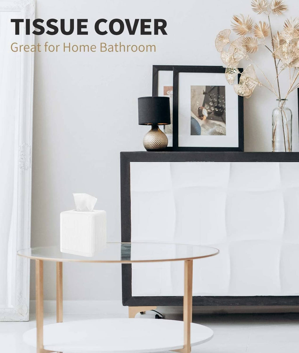 White square plastic tissue cover with open top, placed on a table beside decor.
