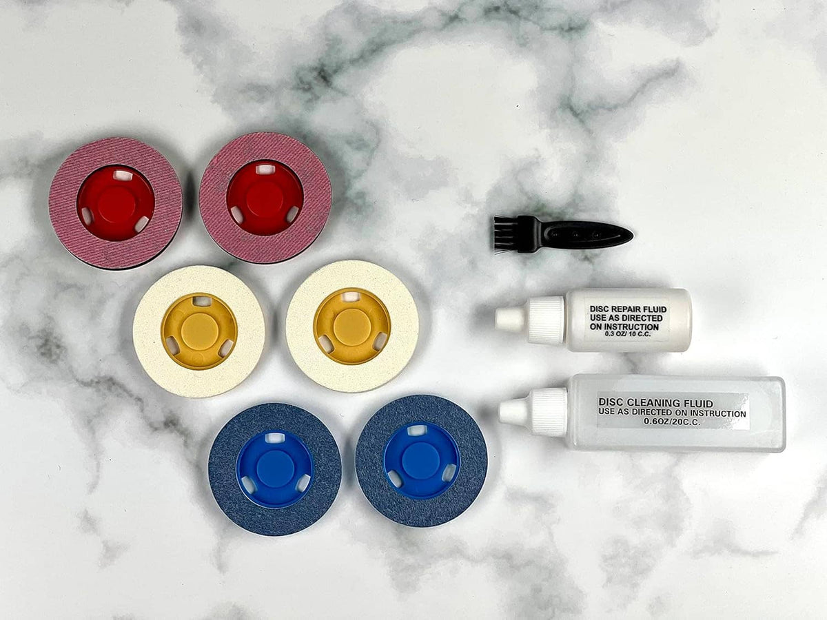 Disc cleaning kit contents: blue, yellow, and red buffing pads plus cleaning bottles
