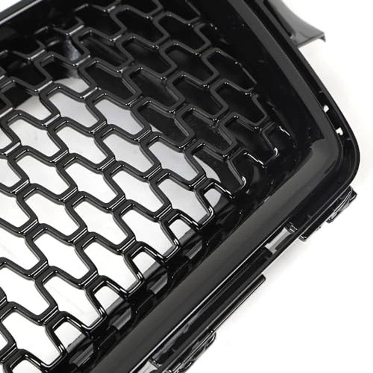 Close-up of black honeycomb mesh grille insert with diamond pattern