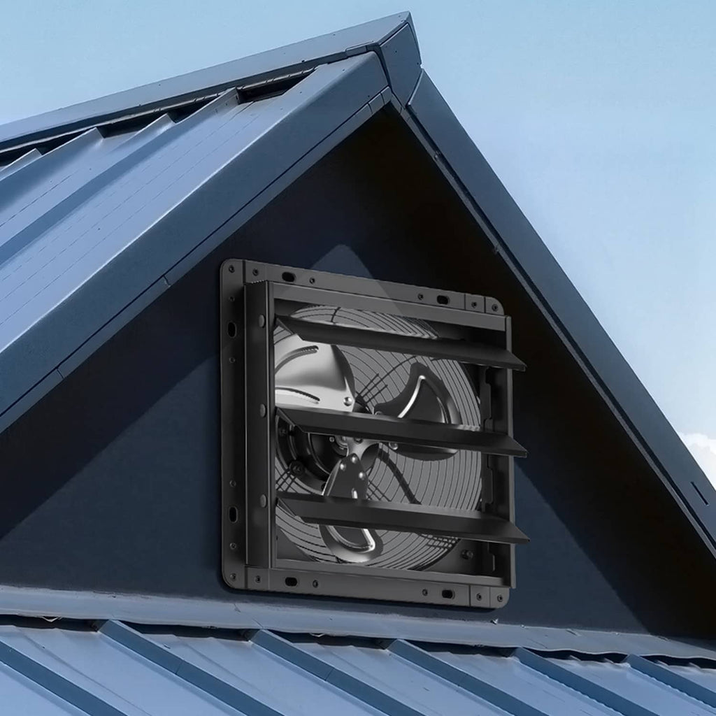 Black wall-mounted exhaust fan installed under roof eave with louvered grille