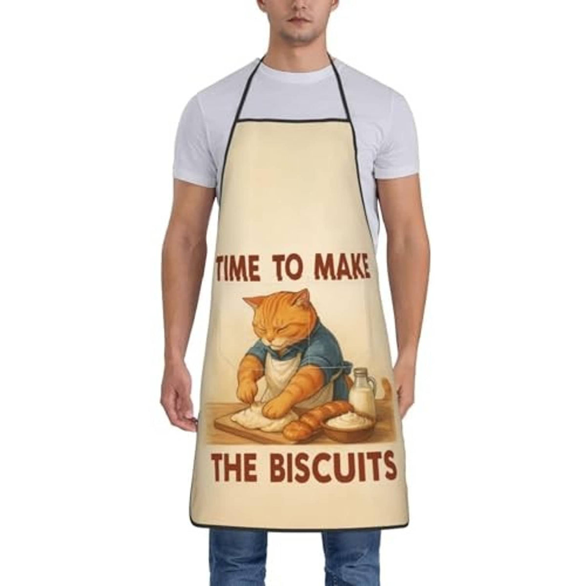 Beige chef bib apron worn by man over white shirt; cat baking and biscuits print