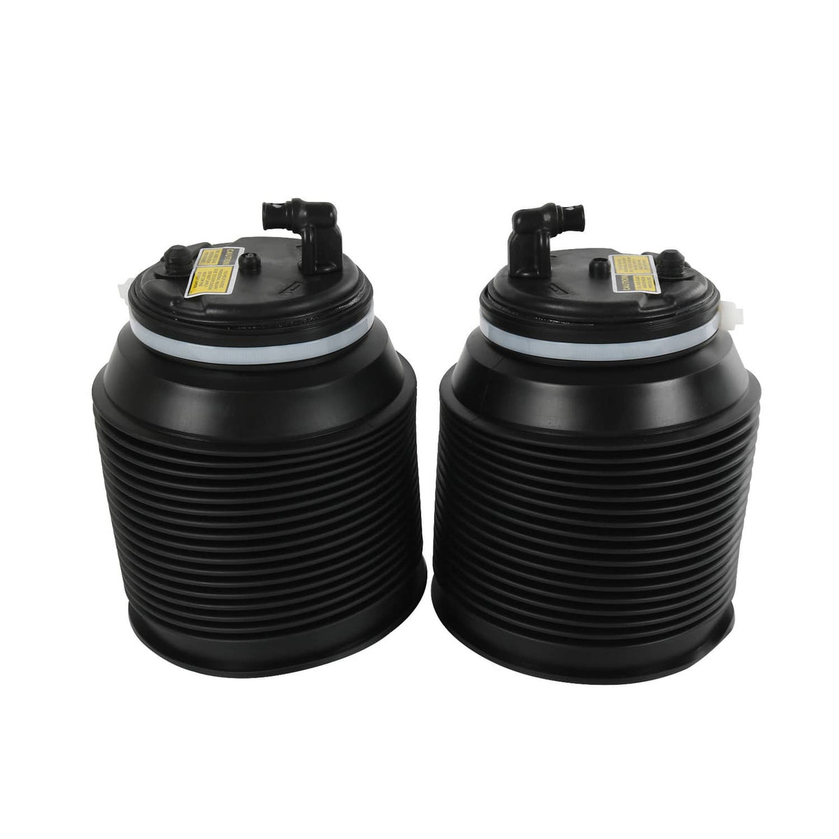 Two black air suspension spring bags with top valves and yellow label stickers installed.