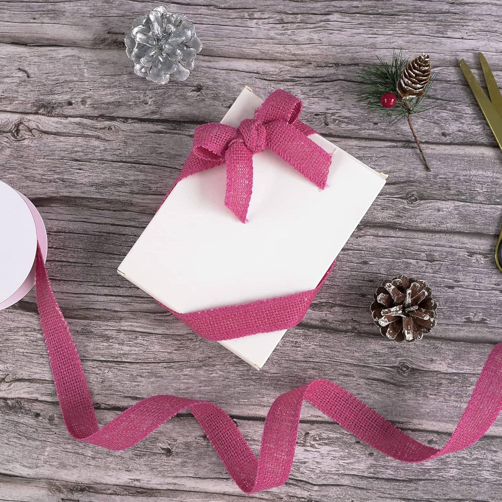 Hot pink burlap ribbon with bow on gift card, loose ribbon tail and woven texture