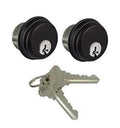 Two keyed cylinder locks with keys, dark finish, round face with keyway emblem