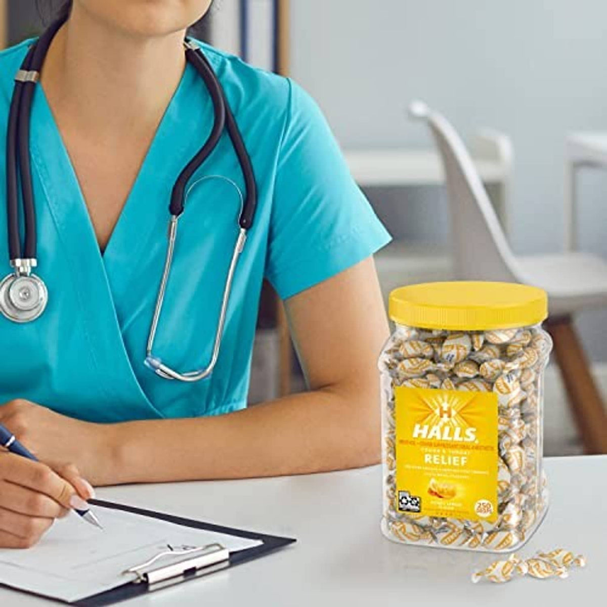 Healthcare professional holding a jar of Halls Relief Honey Lemon cough drops