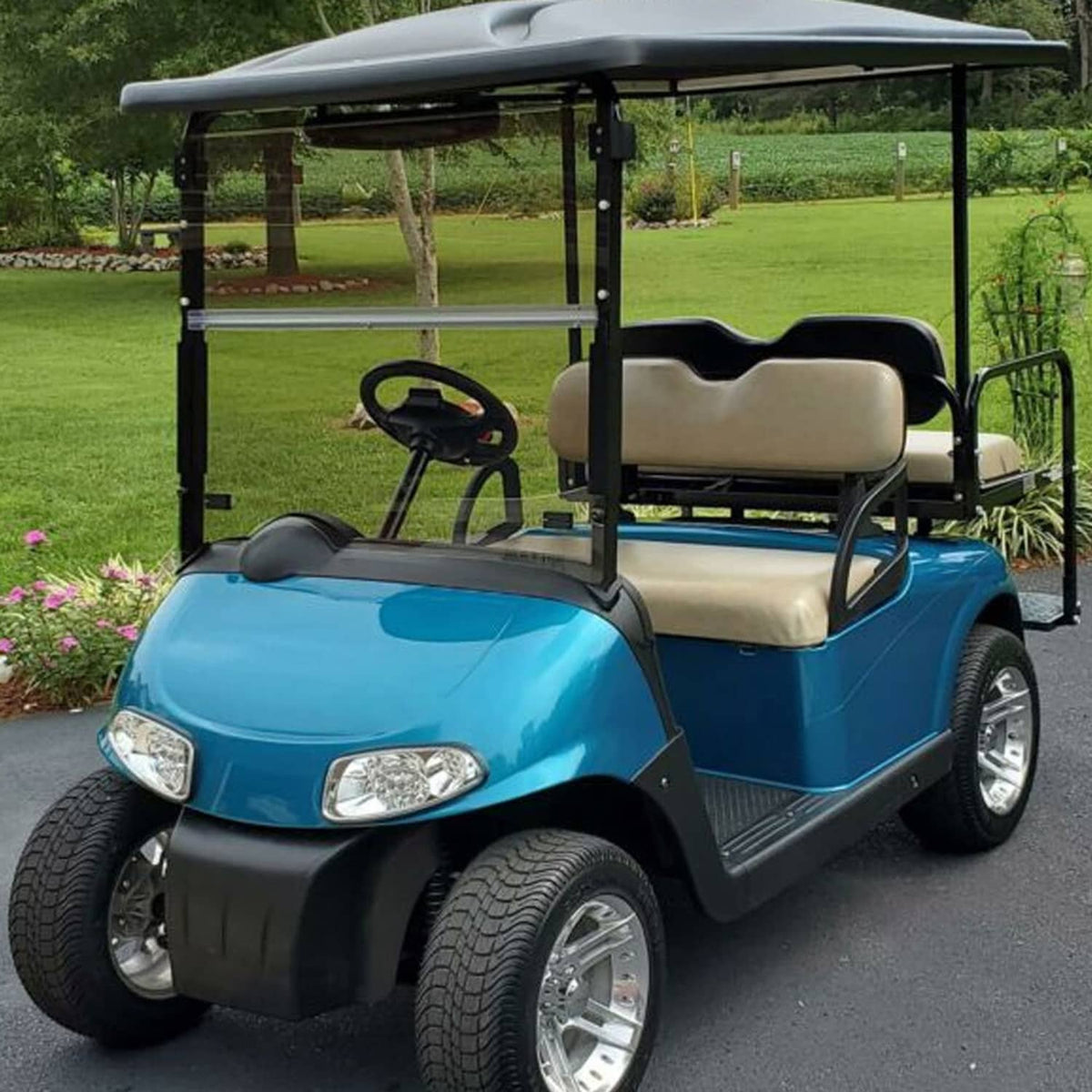 Tinted full front windshield screen on a blue golf cart with beige seats