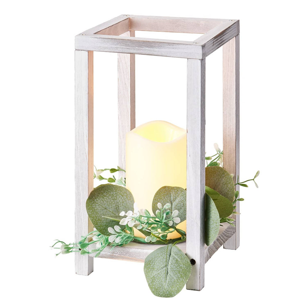 White wooden lantern with LED candle and faux eucalyptus greenery, angled close-up