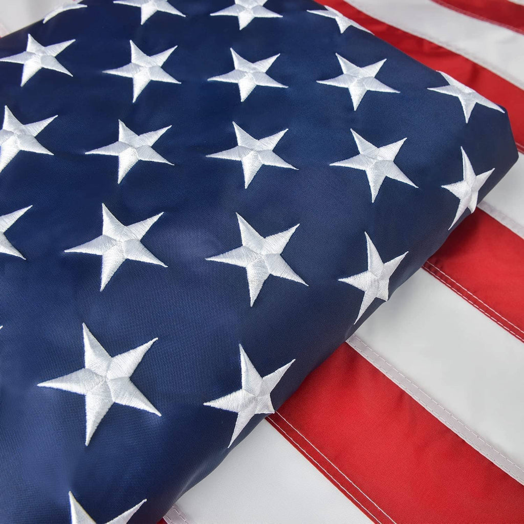 US flag fabric with blue field of white stars and red-and-white stripes, close view.