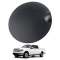 Matte black round gas tank door cover with molded side pull tab detail
