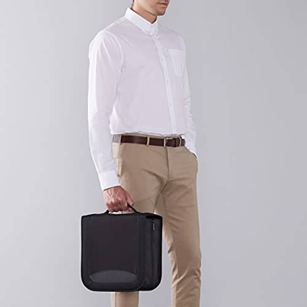 Black CD/DVD binder case being carried by a person in front view