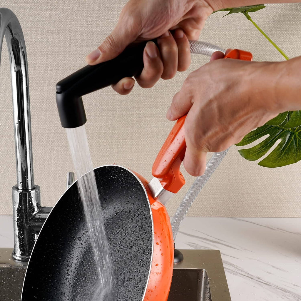Matte black kitchen sprayer head producing a steady spray stream