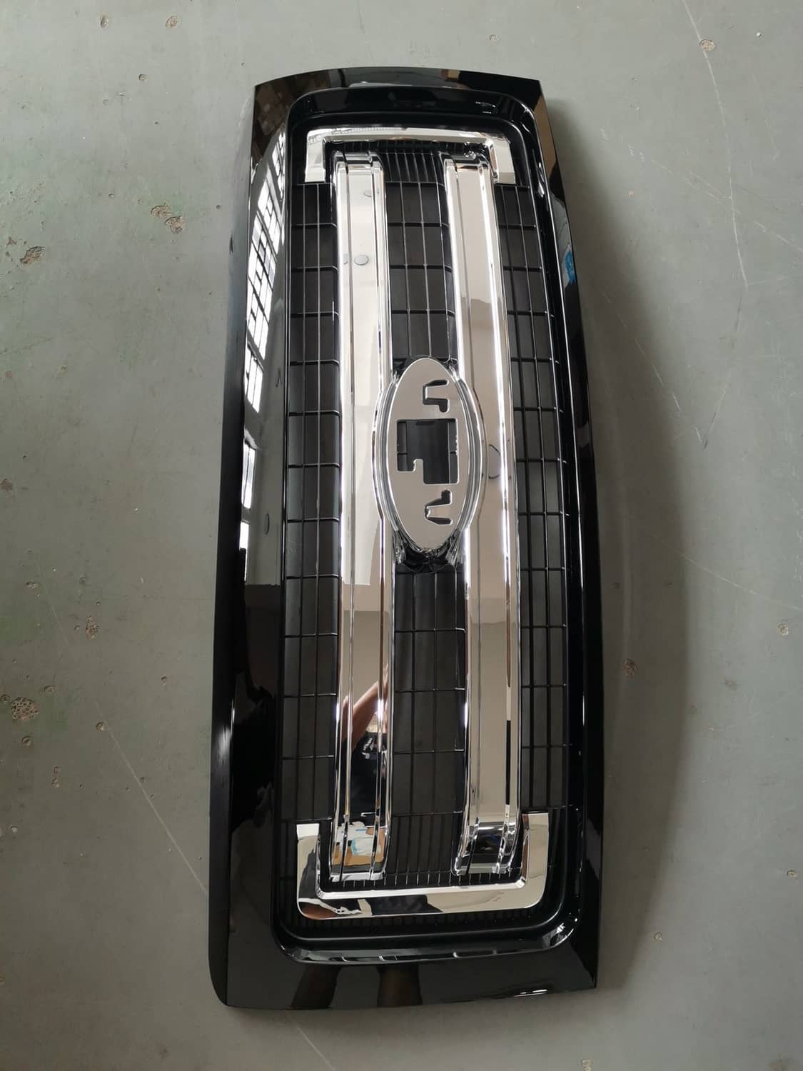 Front upper grille chrome insert with black frame and mounting brackets