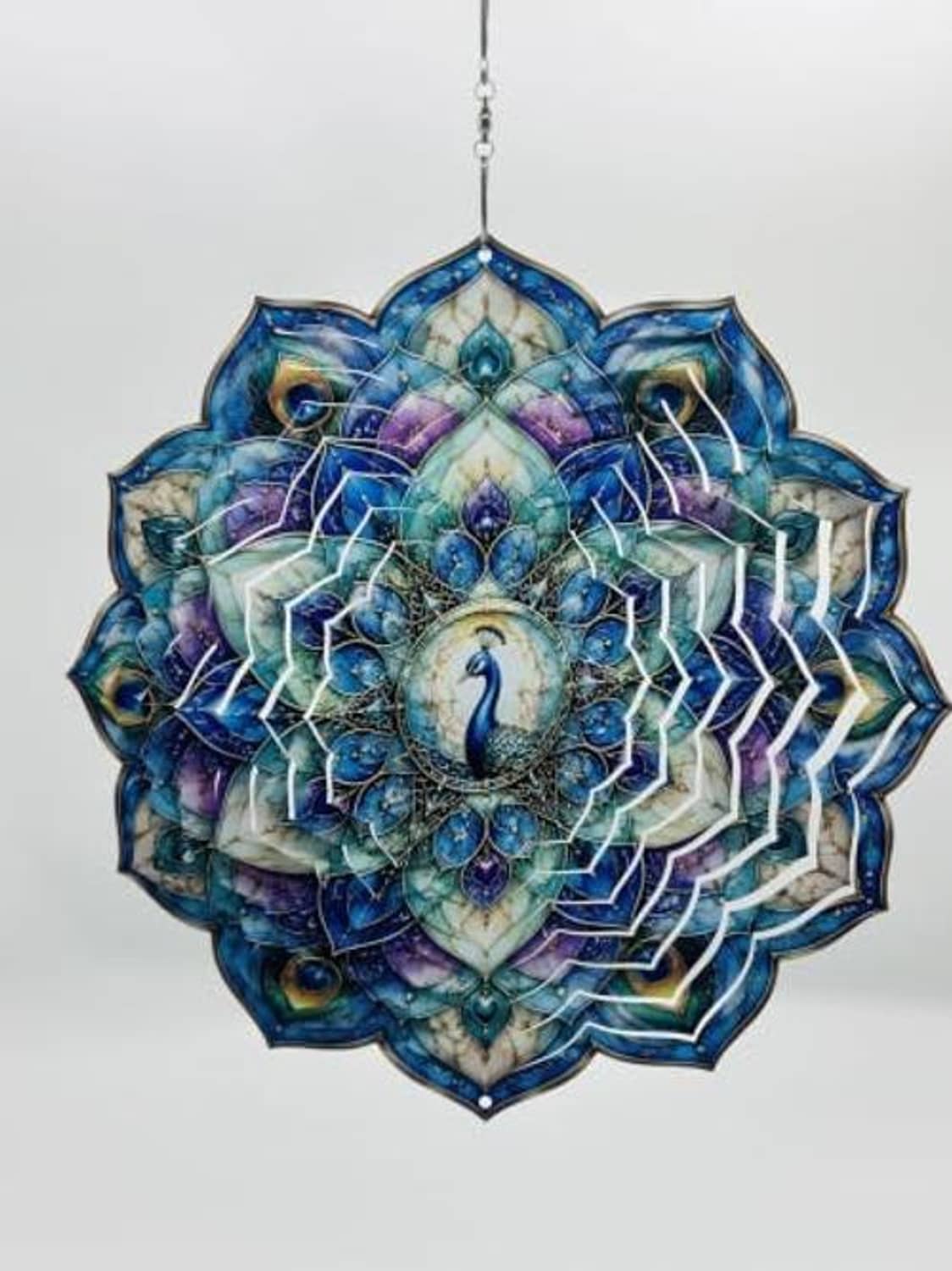 Peacock wind spinner featuring a blue-purple mandala feather fan design, hanging