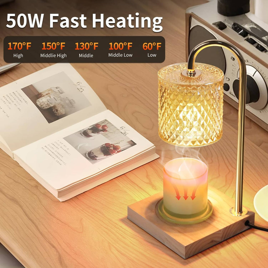 Candle warmer lamp with gold frame, amber textured glass shade, lit candle on wooden base