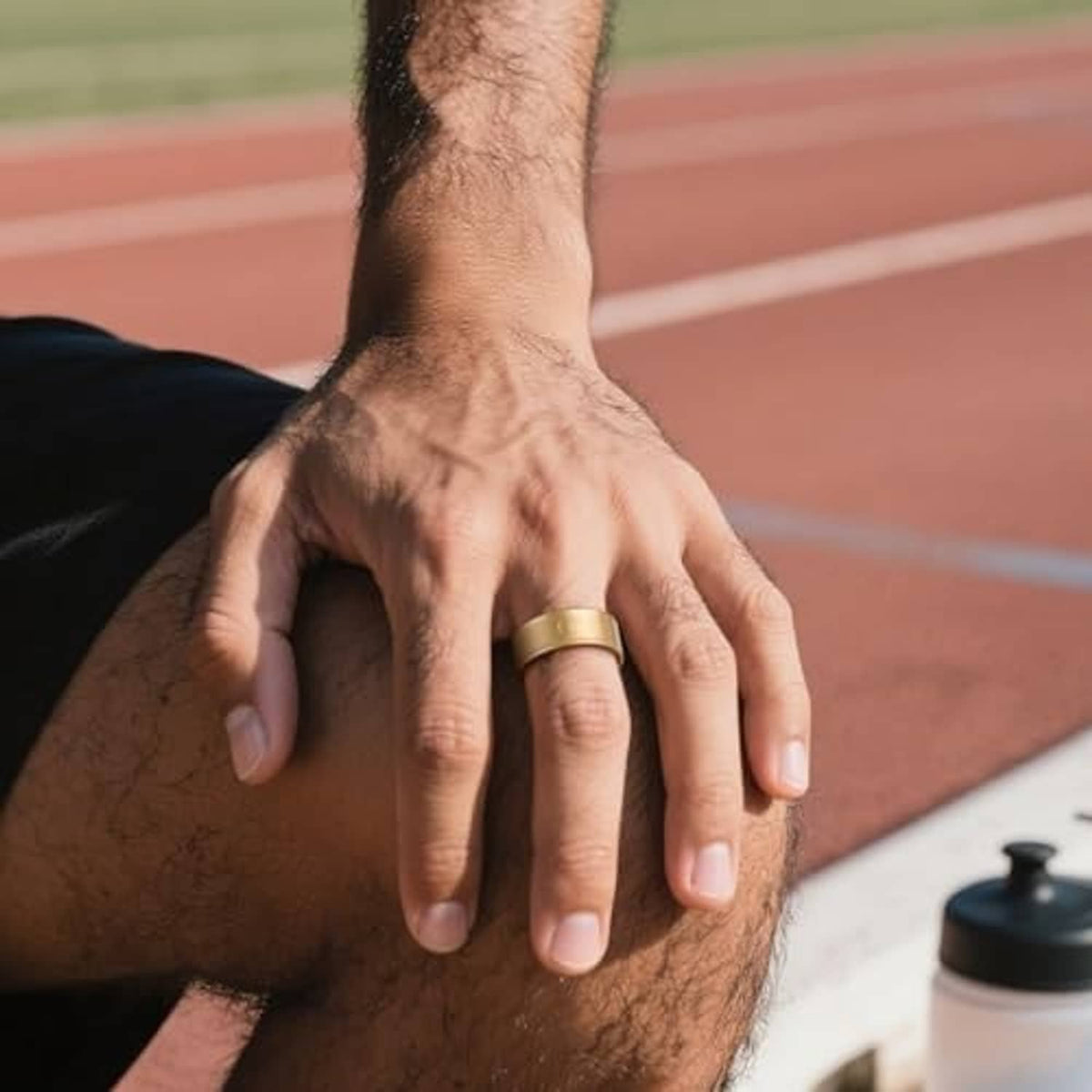 Gold TPU ring cover worn on a man’s finger