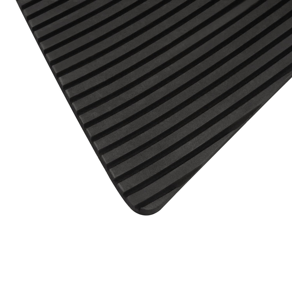 Traction mat foot pad, black ribbed surface close-up with sloped edge