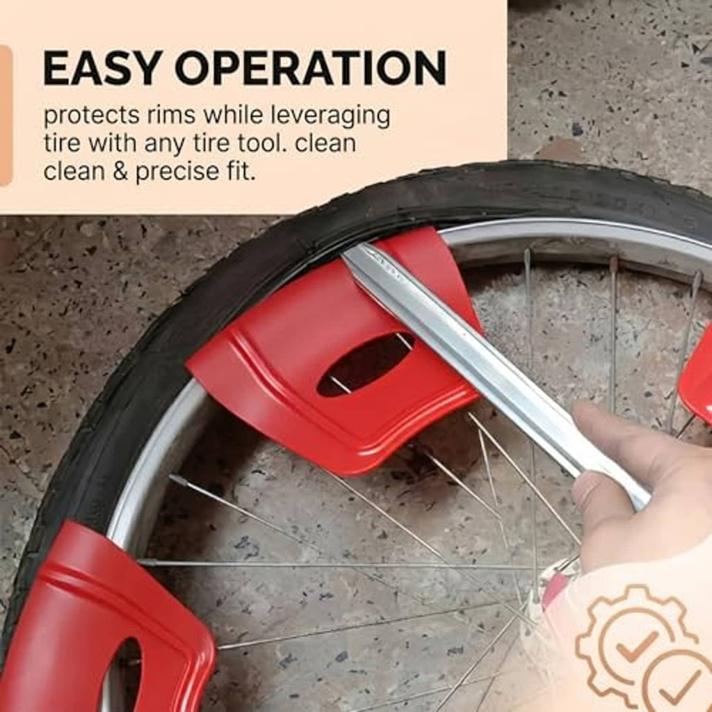 Red rim protectors installed on a bike tire rim with a metal tire lever