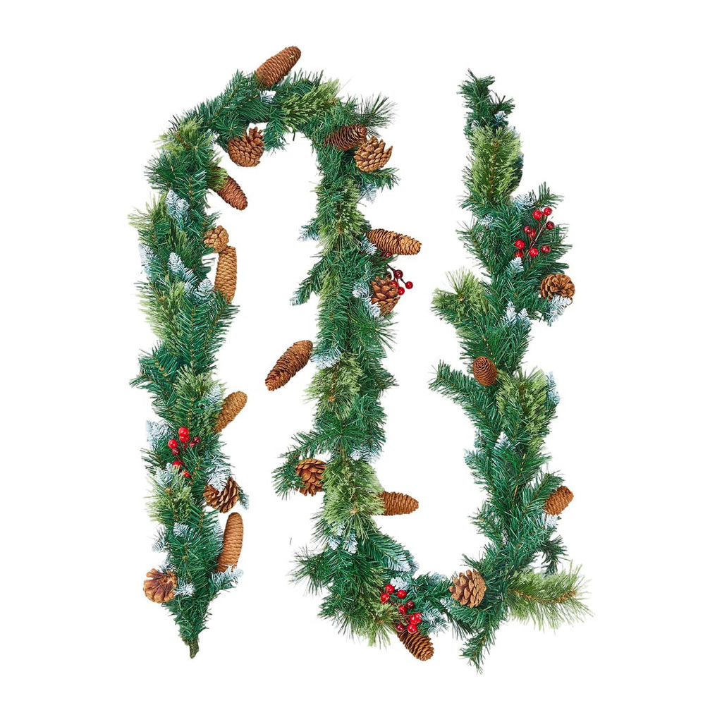 Pre-lit Christmas garland close-up with pine needles, pinecones, and red berries